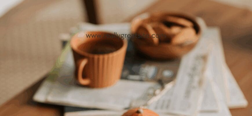 mini pumpkins and a coffee cup on top of a table